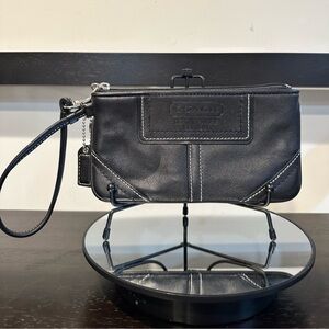 EUC Vintage Coach black leather wristlet with white contrast stitching.